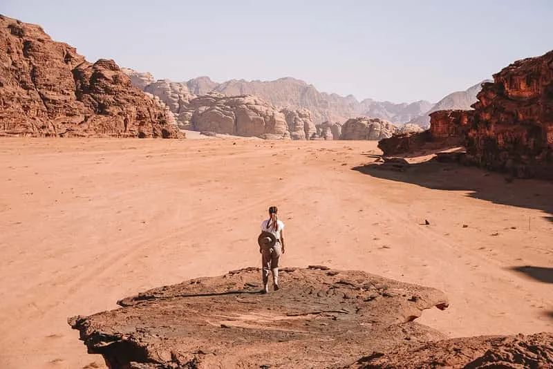 Wadi Rum jeep tour passing towering red sandstone mountains in Jordan's desert